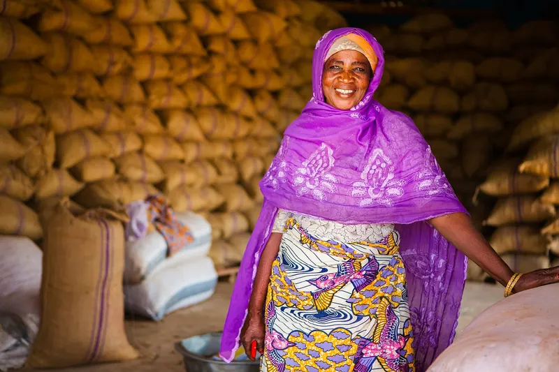 A shea business owner in her warehouse stacked with sacks